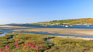 A coastal landscape with a sandy beach, a small stream, and boats in the water. - Llys Bonfyl, Holiday Cottage St Dogmaels, Sleeps 6, 3 bedrooms,  bathrooms (Cardigan)