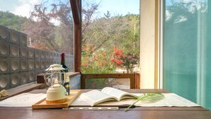 A table with a book, a bottle, and a lantern. - Gyeongju Clearmorning Petfriendlypension (Gyeongju)