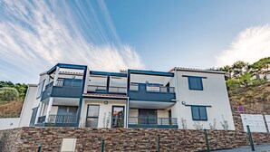 A modern multi-story building with balconies, a stone facade, and a clear sky. - Collioure le haut by Interhome (Collioure)