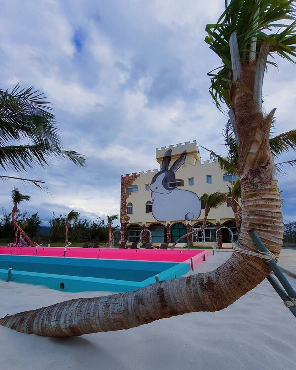 Experience the unique castle-like architecture and vibrant pool area at this resort.