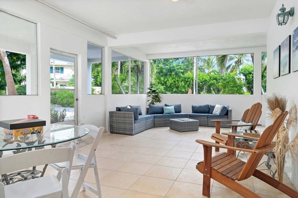 Covered patio with ample seating, perfect for relaxing outdoors.