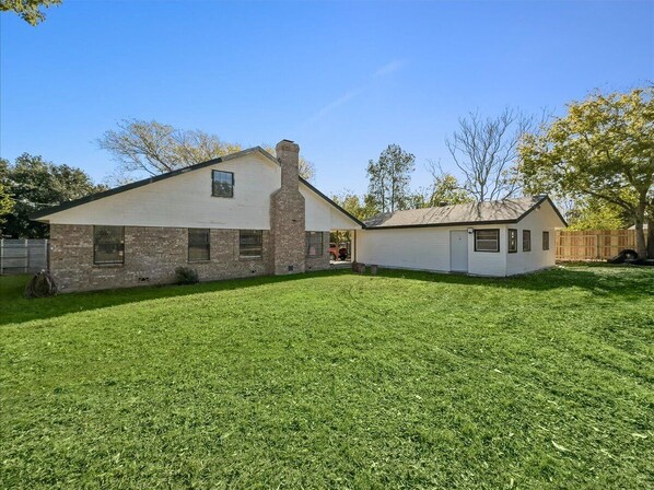 A two-story house with a brick exterior and a white garage.