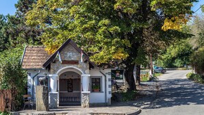 A small, stone building with a sloped roof and a small porch.