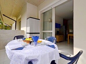 Enjoy meals for two in this cozy dining area with a round table, complete with tableware and a convenient basket for snacks.