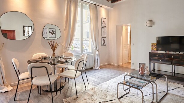 A modern living room with a dining area, a TV, and a fireplace. - Superb Parisian Apartment Center of Paris (Paris)