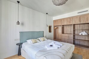 Laptop workspace, iron/ironing board, bed sheets