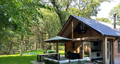 Cosy wooden house with hot tub in forest