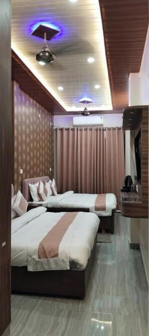 Two single beds with matching headboards and a large mirror adorn this stylish room.