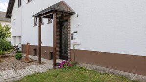 A building with a white facade and a brown lower section.