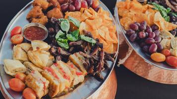 A platter with various food items including bread, meat, and vegetables.