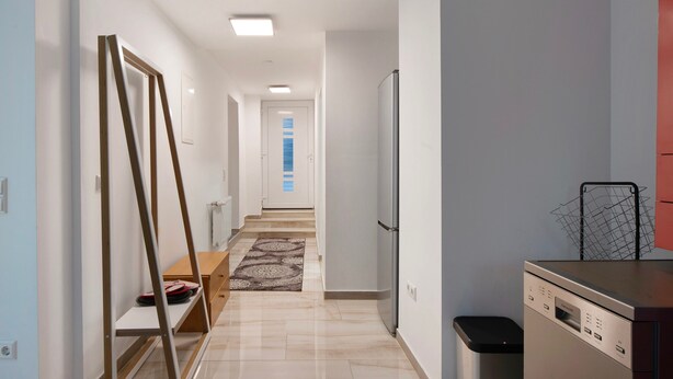 A modern kitchen with a refrigerator, a dishwasher, and a small countertop. - Holiday Apartment Haus Schliengen (Schliengen)