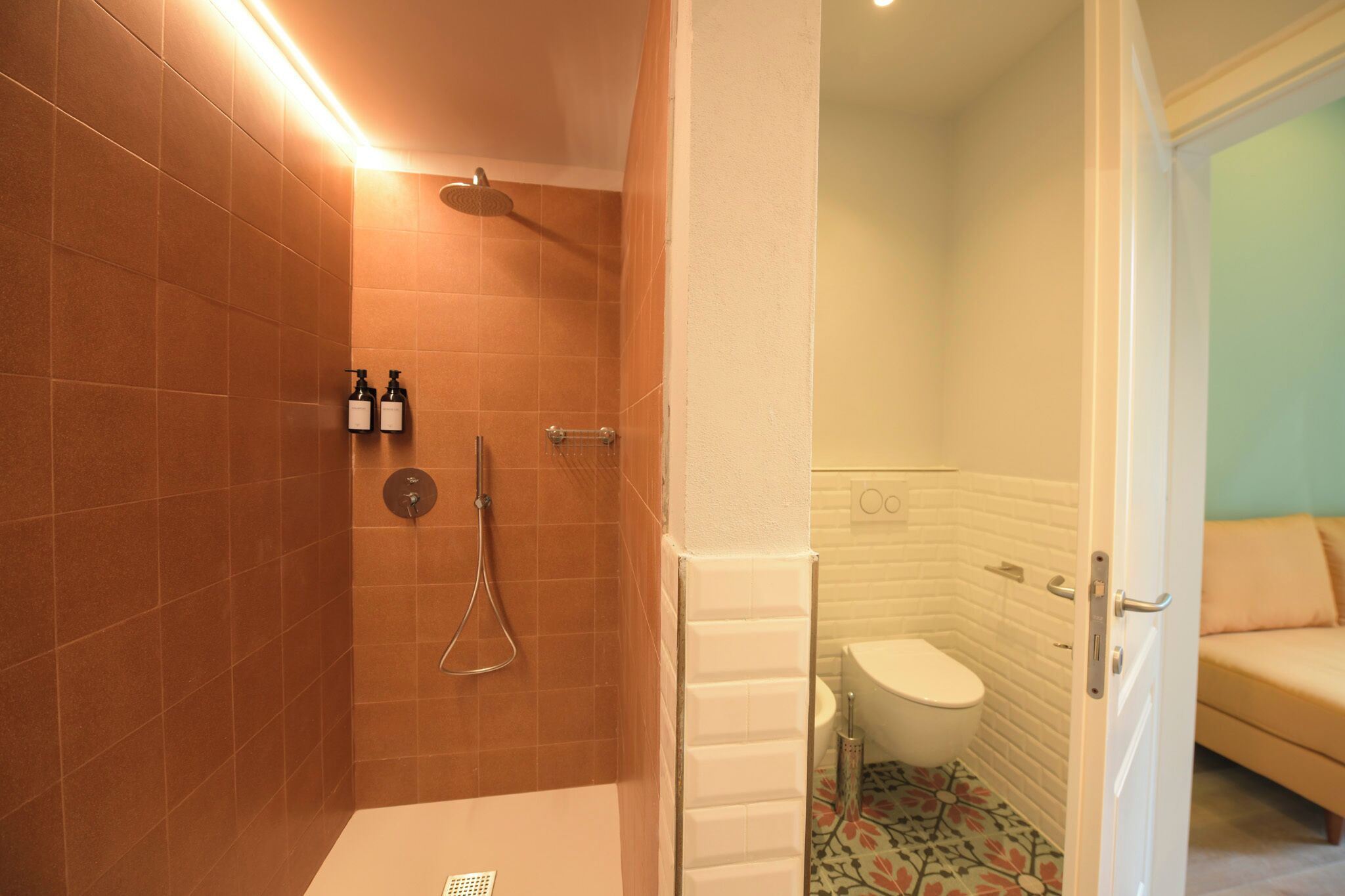 A bathroom with a shower, toilet, and sink.