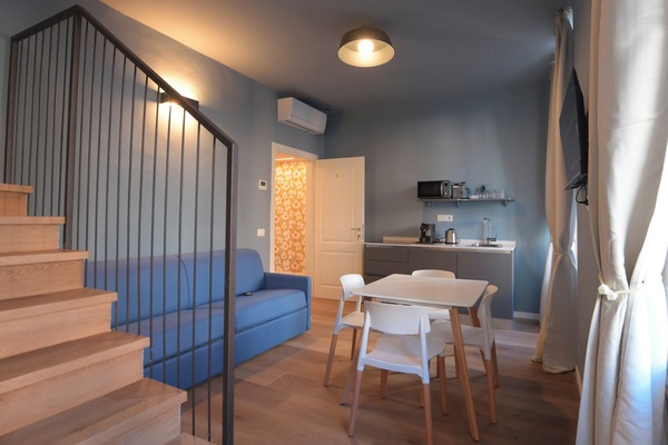 Deluxe Quadruple Room, Balcony | Living area