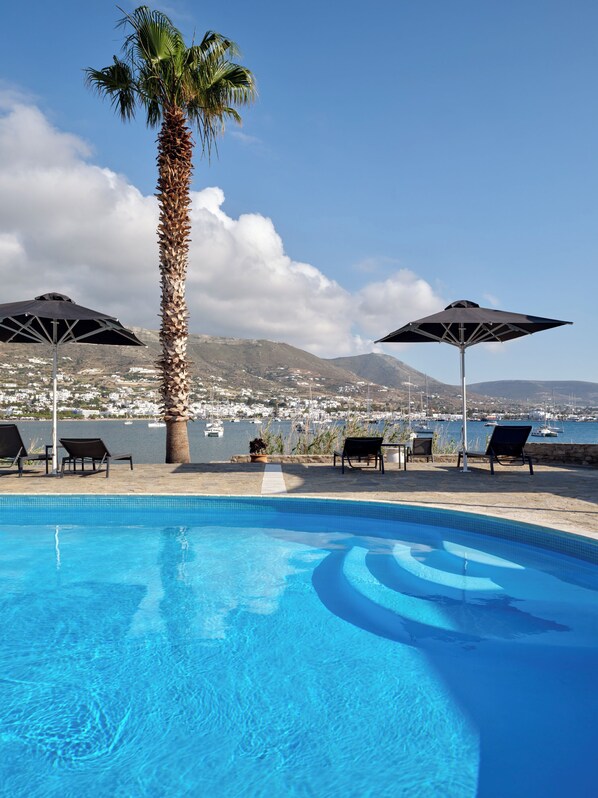 Seasonal outdoor pool, open 9:00 AM to 9:00 PM, pool umbrellas