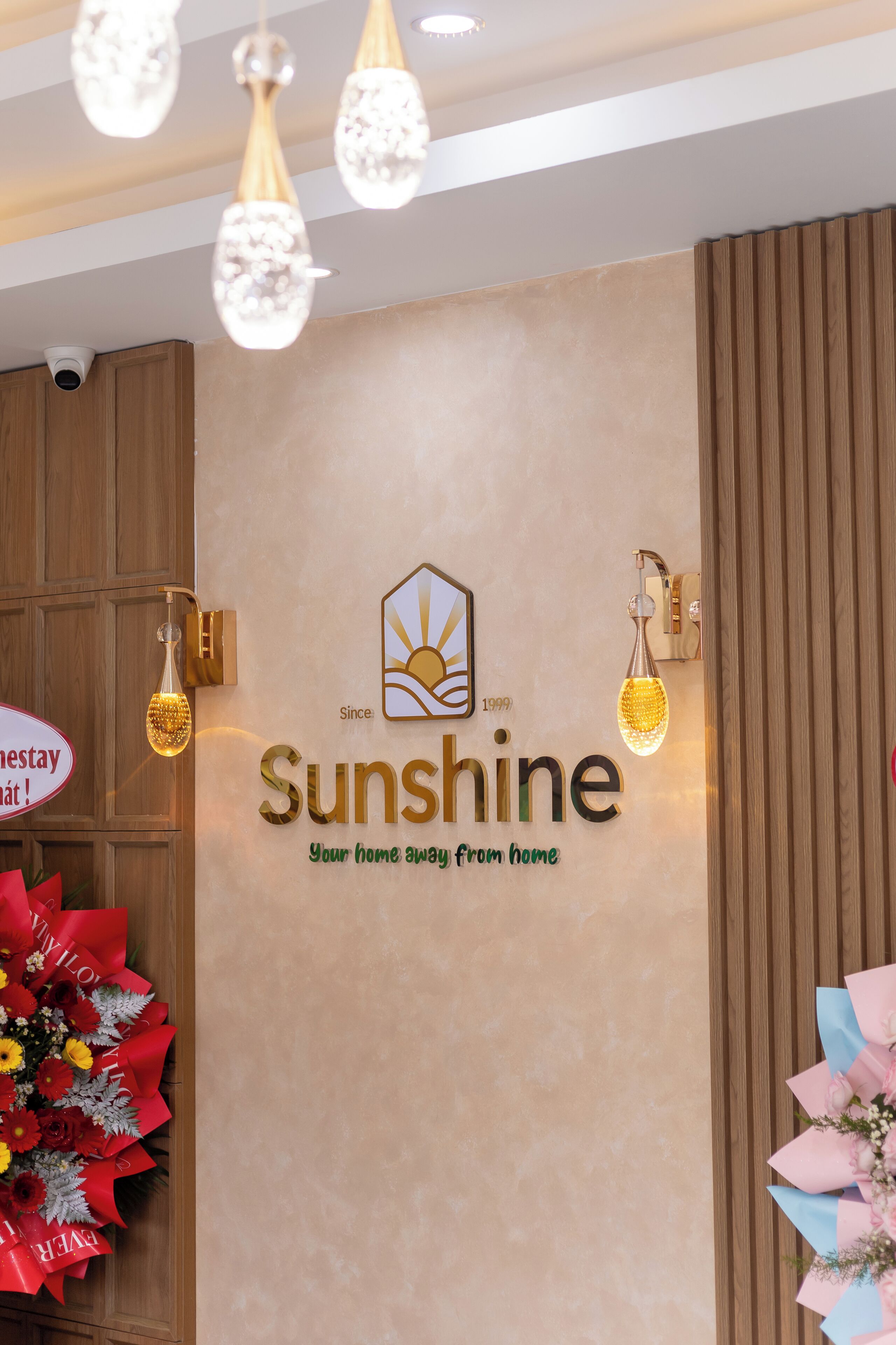 A wall with the Sunshine logo and the tagline "Your home away from home."