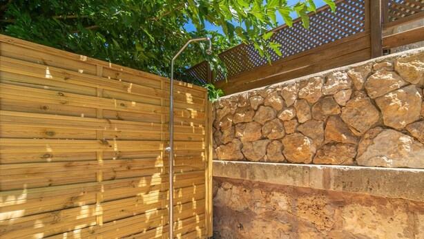 A wooden fence with a stone wall and a metal gate. - Son ArboÇ Gran - Villa With Private Pool (Algaida, Illes Balears)