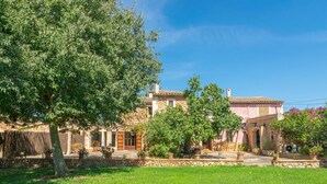 A traditional stone building with a courtyard, surrounded by lush greenery and trees. - Son ArboÇ Gran - Villa With Private Pool (Algaida, Illes Balears)