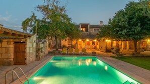 A swimming pool with lounge chairs and a patio area with outdoor seating. - Son ArboÇ Gran - Villa With Private Pool (Algaida, Illes Balears)