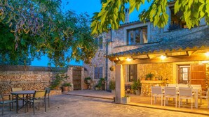A stone building with a patio area, outdoor seating, and a covered dining area. - Son ArboÇ Gran - Villa With Private Pool (Algaida, Illes Balears)
