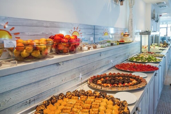 A buffet with various food items including fruits, pastries, and salads. - Oasis Del Mare (Tsarevo)