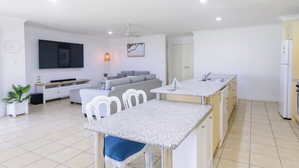 A modern apartment with a living area, a kitchen, and a dining space.