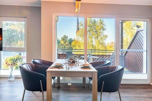 Enjoy meals in this dining area with a table for four and comfortable seating.