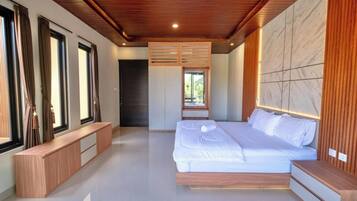 A modern bedroom with a large bed, built-in bench, and a wooden ceiling.