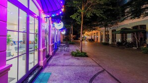 A building with large windows and a covered outdoor seating area. - Alba Sand Hotel Phu Quoc (Phu Quoc)