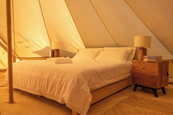 A cozy, tent-like bedroom with a bed, bedside lamps, a nightstand, and a small rug. - Maverick Surf & Dive Boutique Resort - Complimentary Airport Transport for Full Board Stays of 6 Nights or More (Mundoo)
