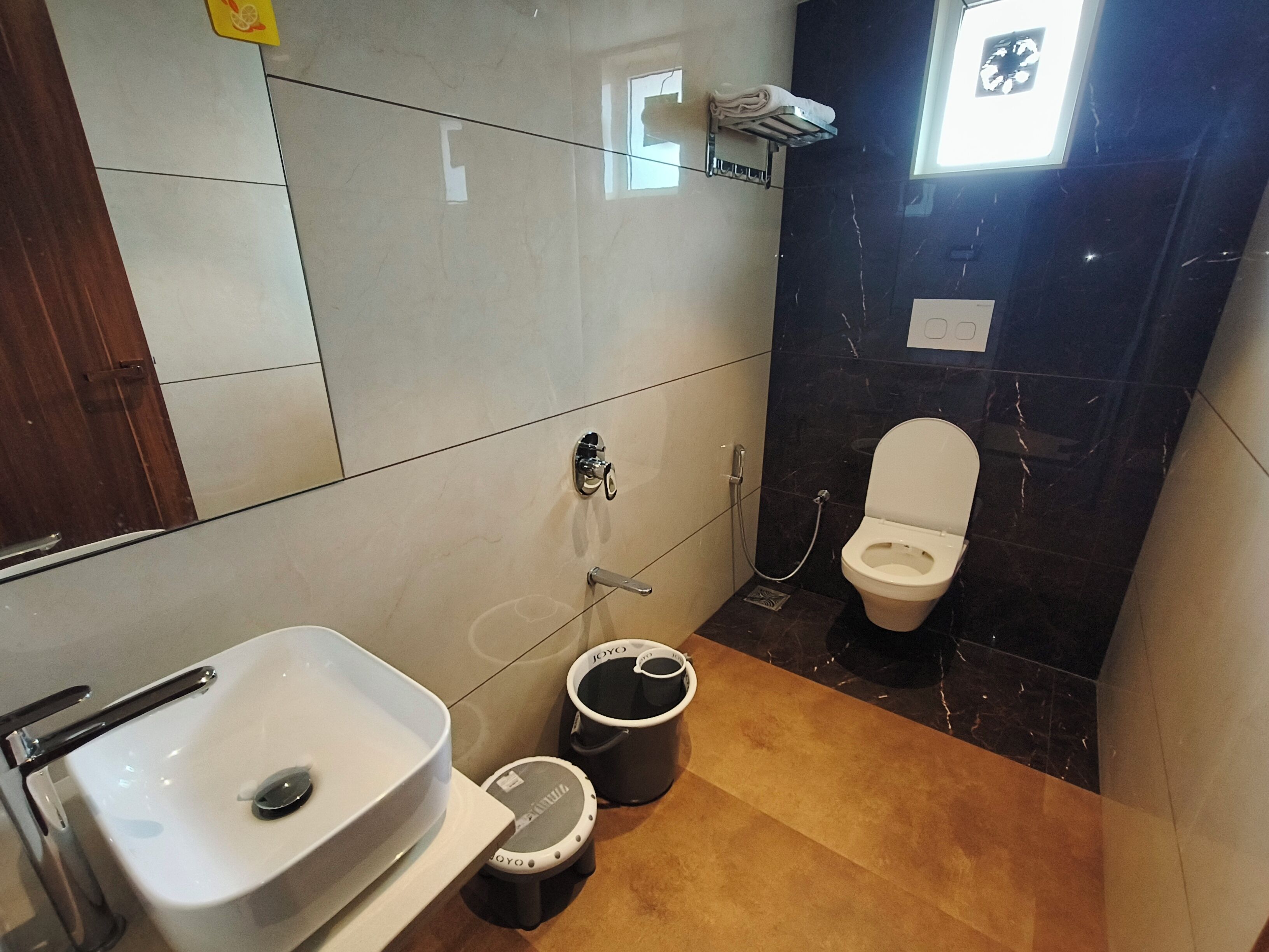 A bathroom with a white sink, a toilet, and a bidet.