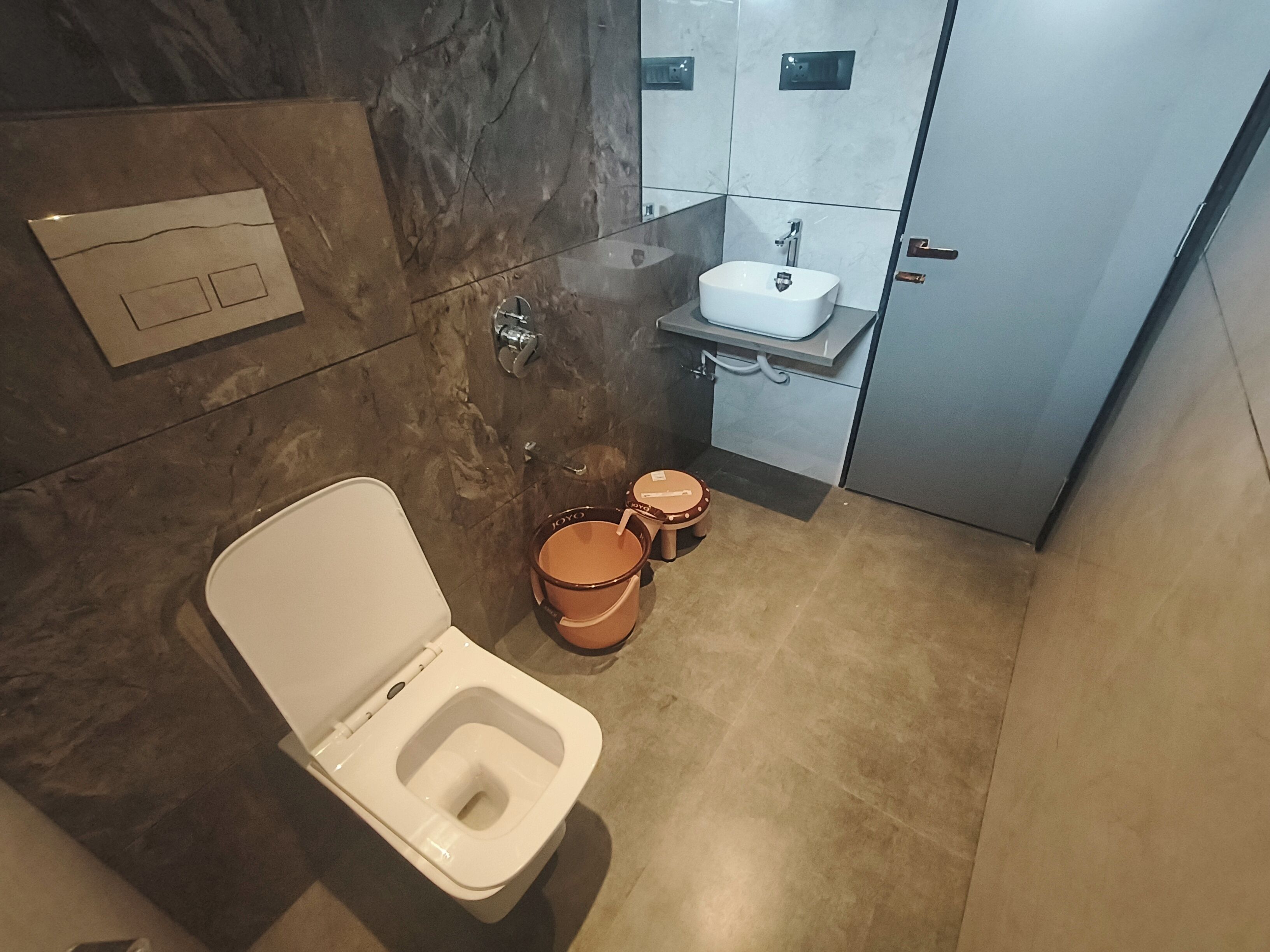 A modern bathroom with a toilet, bidet, and sink.