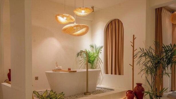 A modern bathroom with a freestanding bathtub, a large mirror, and a potted plant. - Luxury 2BHK Escape w/ Hot Tub, Free Wi-Fi, AC (Kathmandu)