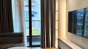 Two-Bedroom Apartment with Balcony | Living area | 32-inch flat-screen TV with cable channels