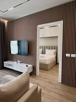 Deluxe One-Bedroom Apartment | Living area | 32-inch flat-screen TV with cable channels