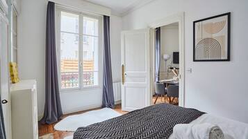 Apartment | Laptop workspace, iron/ironing board, bed sheets