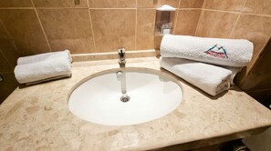 A bathroom sink with two towels on the counter. - Mountain Paradise 2 - Cosy 2 Bed Mountain View Apartment - Washer (Bansko)