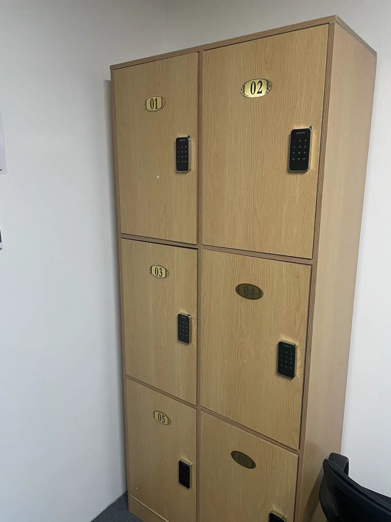 A six-drawer filing cabinet with numbered compartments, each with a lock.