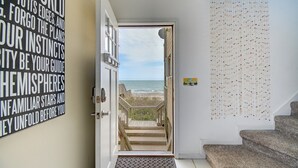 Una escalera lleva a un balcón con vistas a la playa.