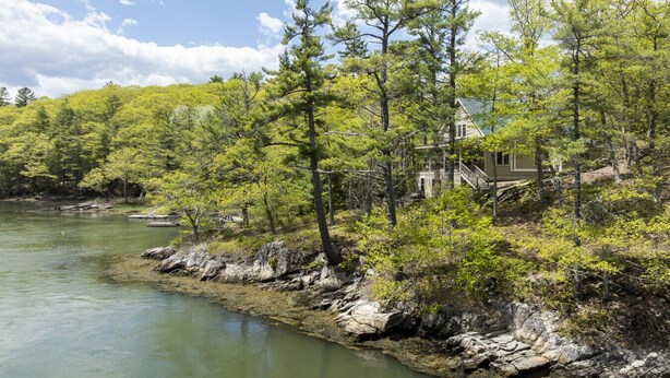 A house by a river surrounded by trees. - Peaceful Riverfront Hideaway | 4BR/3BA | Wildlife, Views & Deep Water Dock (Edgecomb)
