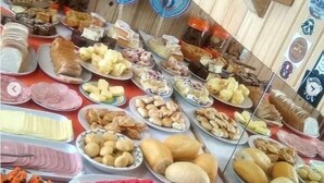 Una mesa de buffet con diversos alimentos y una selección de botellas de vino.