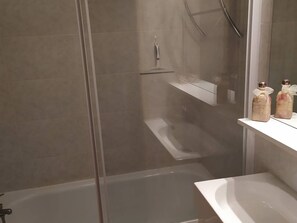 A modern bathroom with a glass-enclosed shower, a white sink, and a mirror above it. - F2 by slopes with WiFi and parking (Les Angles)