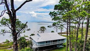 A coastal house with a balcony overlooking a body of water. - Bayfront Home near Salinas Park and Pickleball (Port Saint Joe)