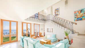A spacious living area with a staircase, large windows, and a view of the sea. - Vacation Home "Mimar Urban Altea Sol" with Sea View, Private Terrace & Wi-Fi (Altea)