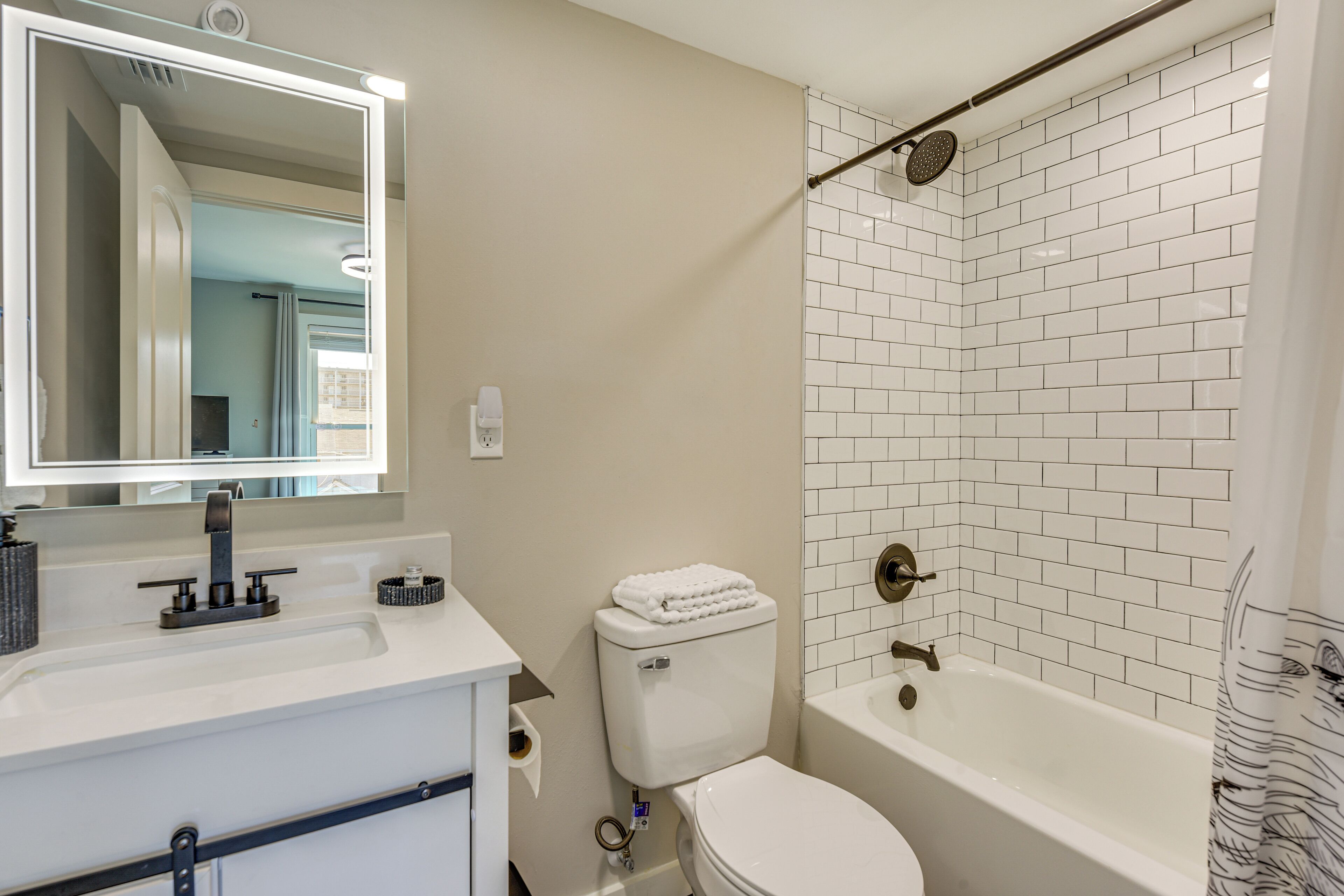 A bathroom with a white sink, toilet, and bathtub.