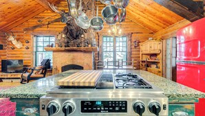 A kitchen with a gas stove, wooden ceiling, and a red refrigerator. - ~ 13 Mi to Main St: Park City Cabin w/ Mtn Views! (Park City)