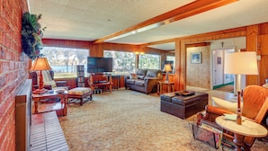 A cozy living room with a fireplace, comfortable seating, and a television. - 6 Mi to Manatee Springs! Family Riverfront Getaway (Chiefland)