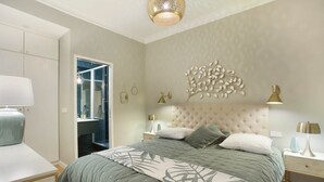A bedroom with a large bed, bedside tables, a wardrobe, and a bathroom visible through an open door. - Sublim and new Apartment Center of Paris / Opera (Paris)