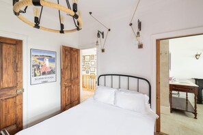 A bedroom with a bed, wooden wardrobe, and a poster of Scarborough. - Host Stay Ranworth (Scarborough)