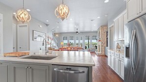 A spacious kitchen with a large island, stainless steel appliances, and pendant lighting. - Lakeside Dreamhouse I Lake, Hot tub, Dogs (Canyon Lake)