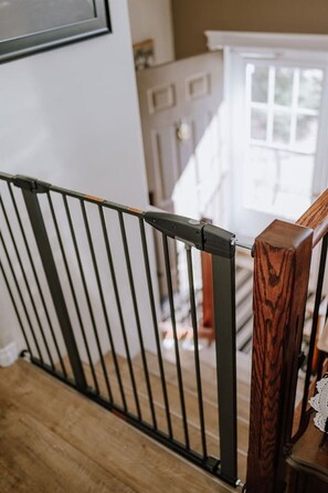 A wooden staircase with a metal railing.